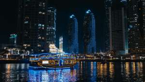 Luxury yacht illuminated at night in Dubai Marina