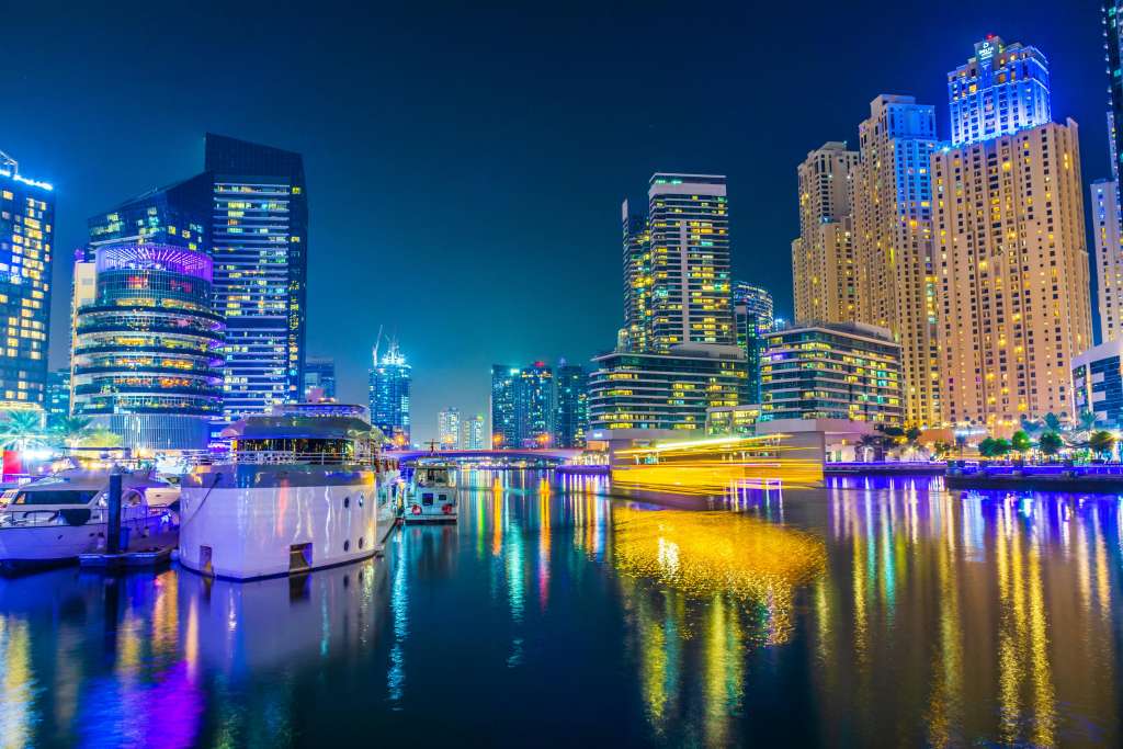 Elegant yacht docked at Dubai Marina with high-rise towers behind